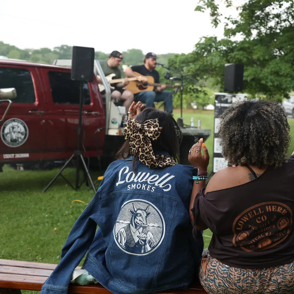 Friends at a Lowell party, one wearing the Lowell Denim Jacket with its bull's-head back print
